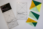 Quilt trimming ruler (4.5) with grid and diagonal seam lines, in clear packaging
