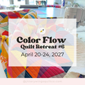 Colorful patchwork quilt with flowing abstract shapes in blues, reds, and yellows